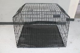 A folding metal dog cage with divider