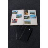 A scrap album containing 20th century tourist postcards, monochrome photographs,