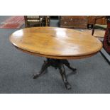 A Victorian inlaid oval breakfast table on carved four way support