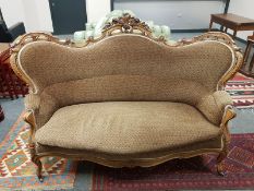 A Victorian carved walnut framed settee,