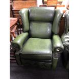 A green buttoned leather Chesterfield wingback armchair