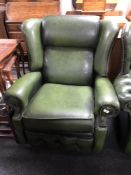 A green buttoned leather Chesterfield wingback armchair