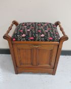 A mahogany storage piano stool