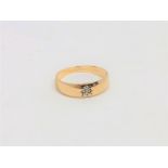 A 9ct gold band ring set with a small diamond, size T. CONDITION REPORT: 2.4g.