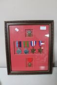 A framed group of five WWII medals with 'The Welsh' cap badge