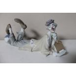 A Lladro figure of a clown lying with foot on ball