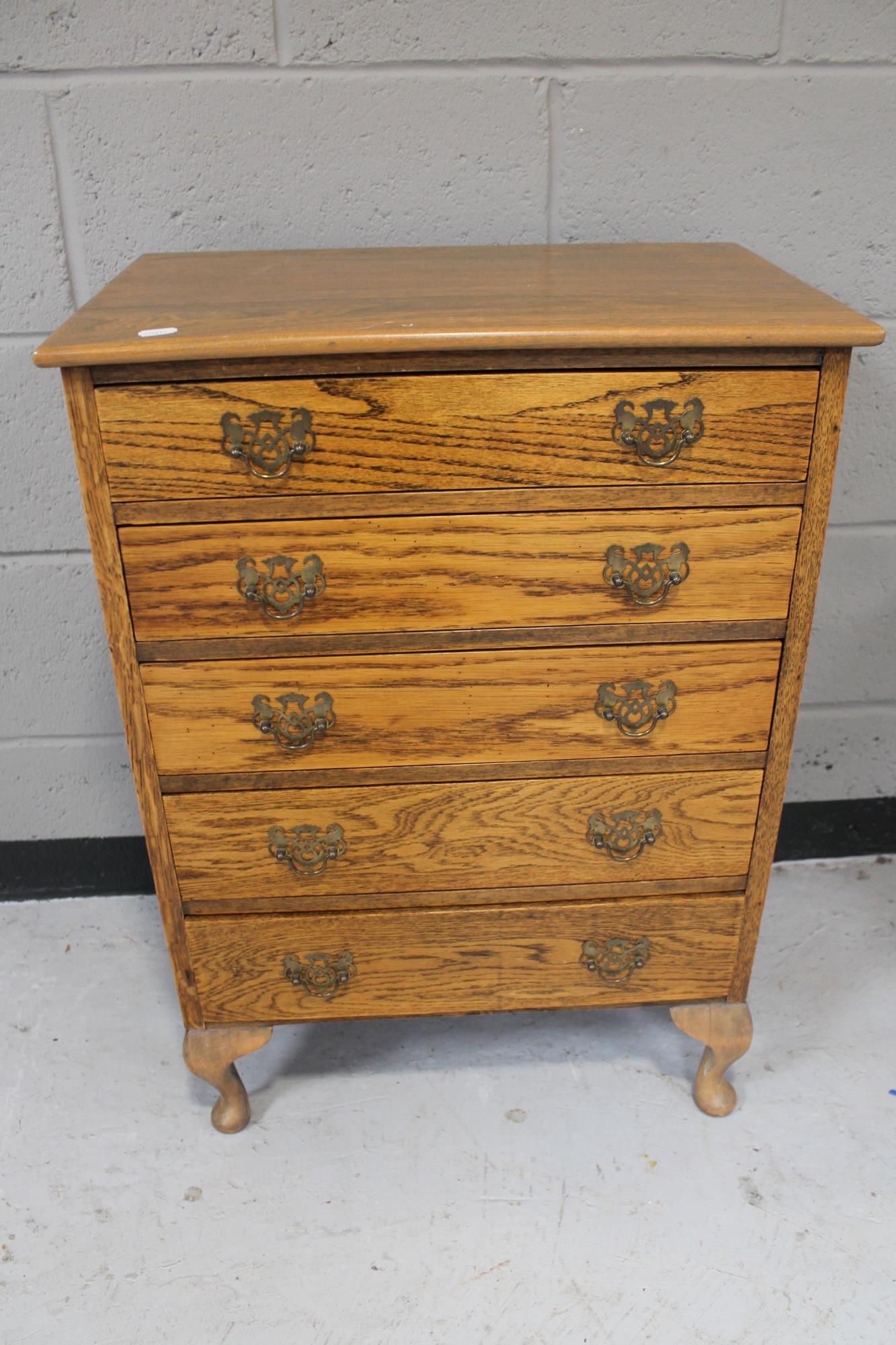 A 20th century oak five drawer chest