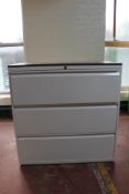 A three drawer metal document cabinet with wood top