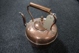 An antique copper kettle by Maurice Co.