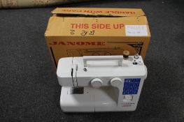 A Janome electric sewing machine with pedal in box
