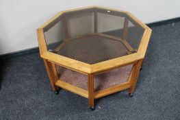 A octagonal glass topped coffee table