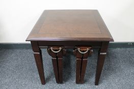 A contemporary inlaid mahogany lamp table fitted with two tables beneath
