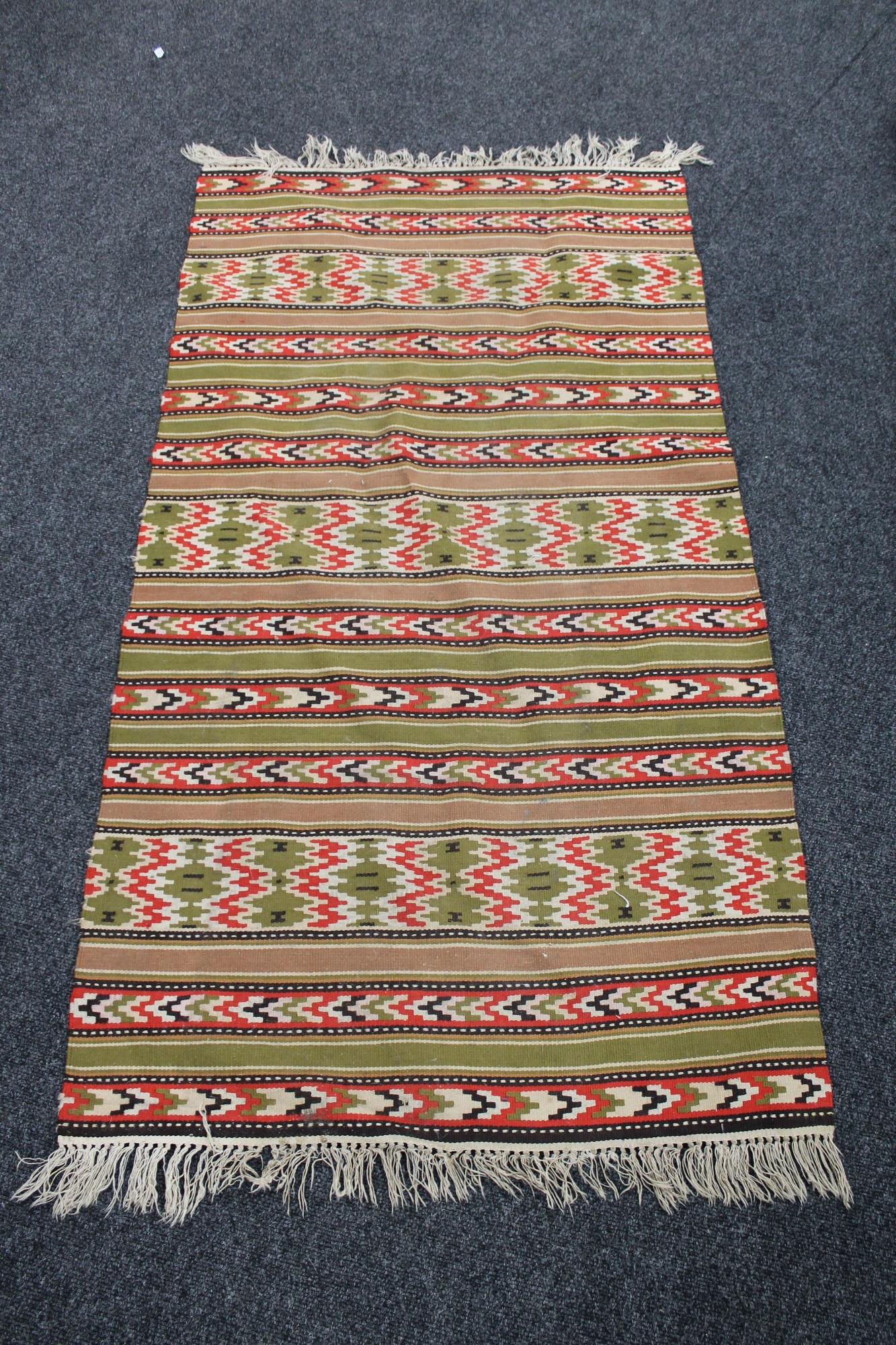 A fringed eastern kilim rug