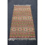 A fringed eastern kilim rug
