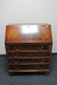 A reproduction mahogany fall front bureau on bracket feet