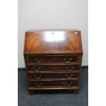 A reproduction mahogany fall front bureau on bracket feet