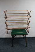 A folding card table and a wooden clothes airer