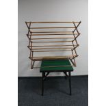 A folding card table and a wooden clothes airer