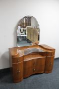 A walnut Art Deco shaped fronted dressing chest
