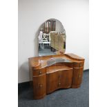 A walnut Art Deco shaped fronted dressing chest