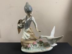 A Lladro figure - a girl feeding geese