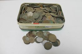 A tin of pre decimal British coins and foreign coins