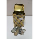 A metal tin of pre decimal British coins and foreign coins