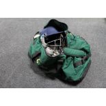 A Metro cricket bag containing cricket accessories to include pads, helmets,