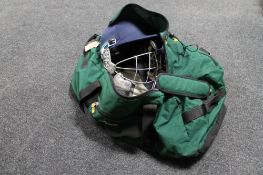 A Metro cricket bag containing cricket accessories to include pads, helmets,