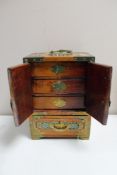 A Chinese metal bound jewellery box fitted with drawers
