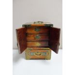 A Chinese metal bound jewellery box fitted with drawers