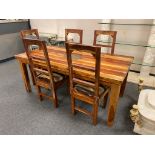A sheesham wood dining room table and five chairs,