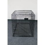 A folding metal dog cage width 67 cm