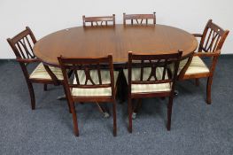 An inlaid mahogany Regency style twin pedestal dining table and six chairs