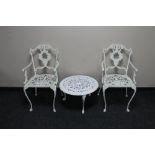 A pair of wrought metal painted patio chairs and circular coffee table