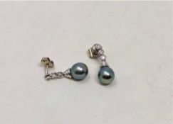 A pair of Tahitian pearl and diamond earrings