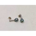 A pair of Tahitian pearl and diamond earrings