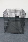 A folding metal dog cage width 67 cm
