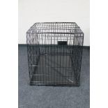 A folding metal dog cage width 67 cm