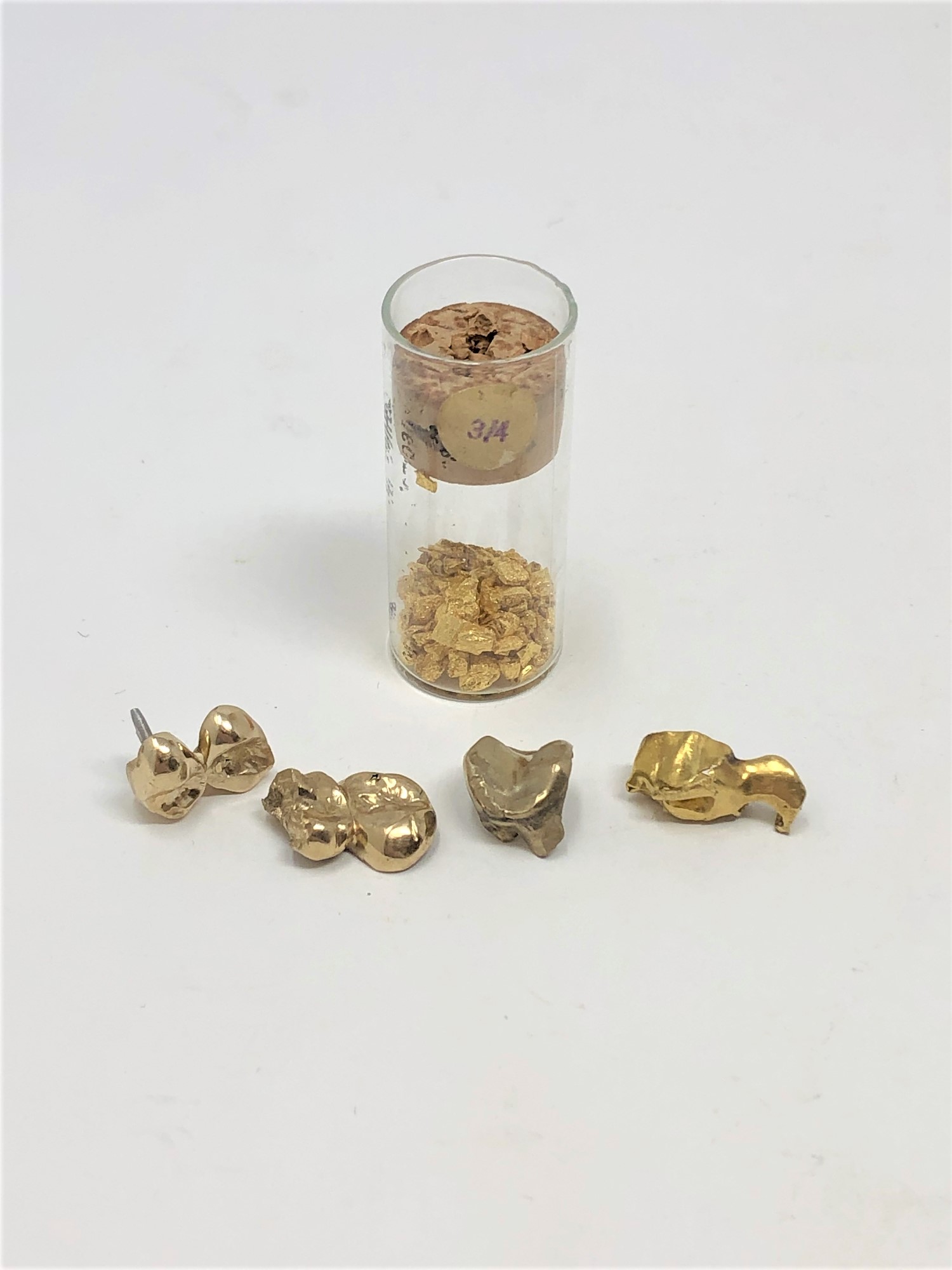 A quantity of dental gold (13.6g), together with a further glass vial containing dental gold.