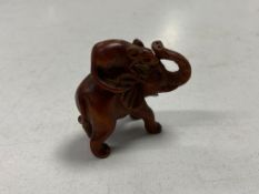 A Japanese carved wooden netsuke in the form of a rat riding on the back of an elephant