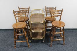 Four elm kitchen bar chairs and a gilt three tier trolley