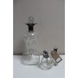 A glass decanter with silver collar together a twin glass oil dispenser with silver collar