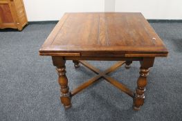 An oak early 20th century pull out dining table