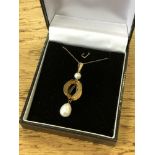 A pearl pendant set in yellow gold on chain