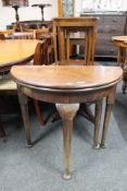 A Victorian D-shaped turnover top table on club feet