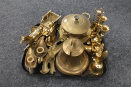 A tray of brass wares, hand bell, mining figure, horse and cart, candlesticks,