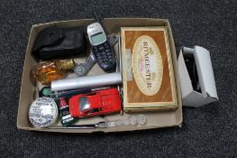 A collection of match cases, die cast cars, mobile telephone, pens,