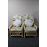 A pair of bamboo and wicker conservatory chairs with cushions