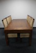 A contemporary rectangular dining table and six high back wicker dining chairs